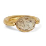 A gold ring with scarab setting, the thick rounded gold band tapering at the bezel, 2.9cm. diam.