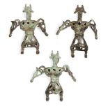 Three Amlash bronze openwork figures, 1st millennium B.C., standing their feet apart, horned and