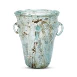 A Byzantine pale bluish-green hanging glass lamp, 6th-7th century, the hollow tubular rim on a