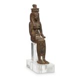 An Egyptian bronze seated figure of Isis, Late Period, 664-332 B.C., depicted seated, wearing a