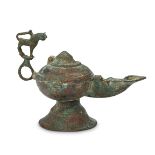 A Khorasan bronze oil lamp with lion handle, Iran, 12th-13th century, on a spreading foot, the spout
