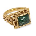 A carved emerald set gold ring, India, 20th century, the square bezel set with an emerald carved