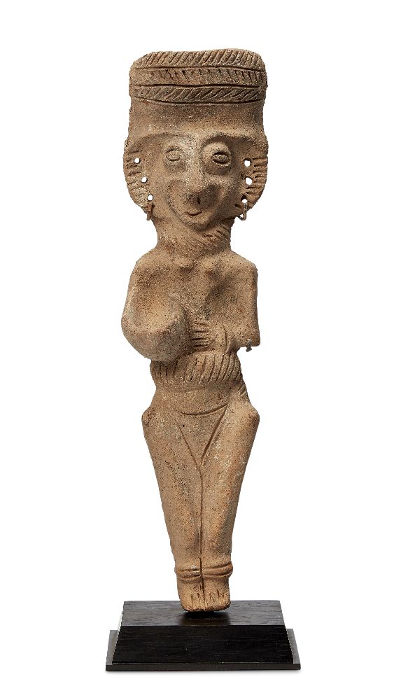 A Cypriot terracotta figure, circa 1000 B.C., modelled as a Goddess with an incised headdress,