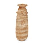 A Bactrian calcite cylindrical ritual vessel, 11th century B.C., with carved concentric grooves to