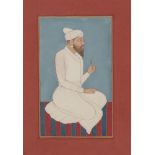 A Pahari nobleman seated on a striped dhurrie, Punjab Plains, circa 1840, gouache on paper,