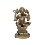 A small bronze figure of Ganesha, 18th century, shown seated on a square, tiered base, with curled