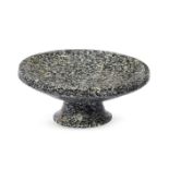 An Achaemenid granite footed bowl, circa 5th century B.C., the thick tapering foot splayed at the