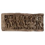 A carved wood panel, India, late 18th century, depicting a series of dancers in movement, wearing