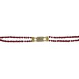 A garnet bead necklace, the double row of faceted garnet beads to an engraved box clasp, 60.0cm