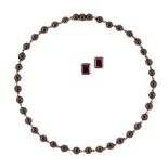 A 19th century garnet necklace, composed of a line closed-set circular cabochon garnets, mounted