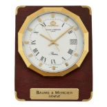 A steel and gilt quartz 'Riviera' desk clock by Baume & Mercier, the circular dial with Roman