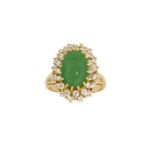 A jadeite jade and diamond cluster ring, the oval jade cabochon to diamond double row surround,