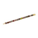 A mid 20th century gold and gem bracelet, composed of a series of claw set square-cut gemstones,