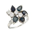 A diamond and sapphire cluster ring, of abstract floral design, with pear shaped sapphire petals and
