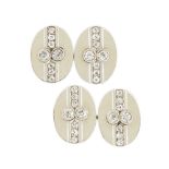 A pair of diamond cufflinks, each oval panel with old brilliant-cut diamond two stone centre and