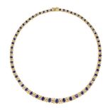 A sapphire and diamond necklace, composed of a line of graduated oval sapphires with graduated