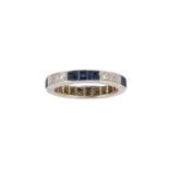 A platinum, sapphire and diamond eternity ring, composed of a single-row of alternately set three
