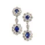 A pair of sapphire and diamond ear pendants, composed of two graduated clusters, the drops with oval