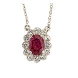 A ruby and diamond cluster pendant necklace, the oval ruby within a brilliant-cut diamond
