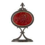 A late 19th century silver mounted glass intaglio desk ornament, the oval intaglio depicting a scene