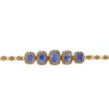 A sapphire bracelet, the front set with a line of graduated cushion shaped sapphires in pierced