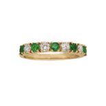 An emerald and diamond nine stone half hoop ring, composed of an alternating line of circular-cut