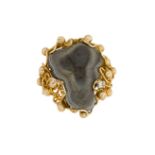 An agate geode ring, the freeform geode within an open wirework abstract design mount with bead