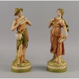 A pair of Royal Dux porcelain figures of an Alpine boy and girl, late 19th/early 20th century, he