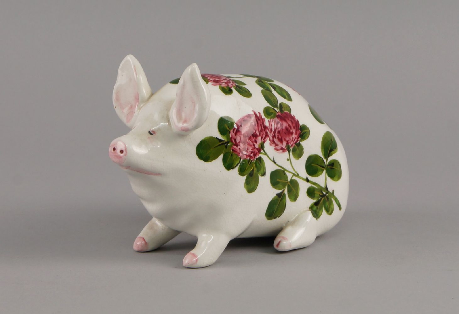 A small Wemyss pig, decorated with chrysanthemums and foliage, marked Wemyss, with printed mark to