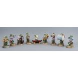 A nine piece Sitzendorf porcelain frog band, late 19th/early 20th century, each player seated on a