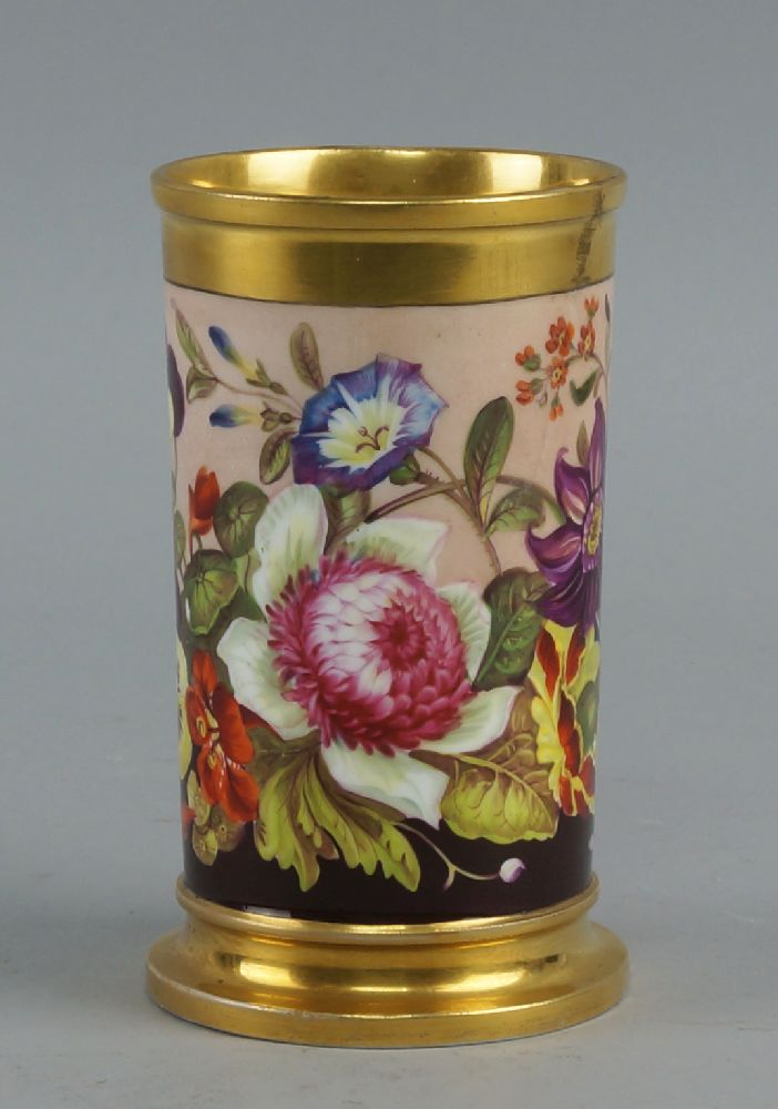 A Rockingham cylindrical spill vase, 19th century, decorated with a band of flowers and foliage