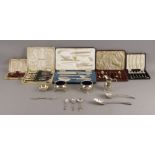 A collection of silver comprising three mustard spoons, sixteen coffee spoons, a pair of George