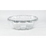 A large oval hand cut glass basin, 20th century, with thick moulded rim, the body of lobed form,