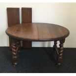 An early 20th century two leaf oak barley twist dining table