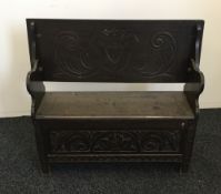 A Victorian carved oak monks bench