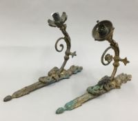 A pair of bronze wall lights