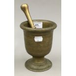 A bronze pestle and mortar