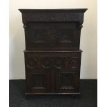 A 17th century style carved oak court cupboard