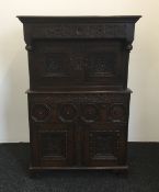 A 17th century style carved oak court cupboard