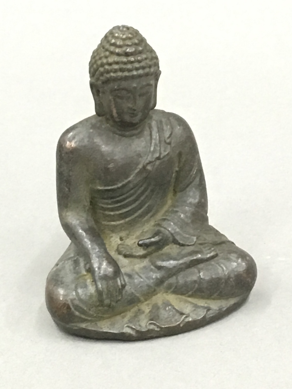 A small bronze model of Buddha