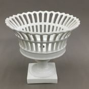 A 19th century white glazed pedestal basket