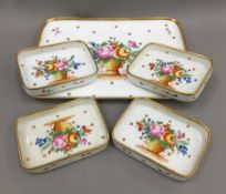 A Continental porcelain florally decorated tray and four small matching dishes