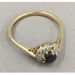 An unmarked gold diamond and sapphire ring