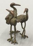 A bronze figure of three cranes