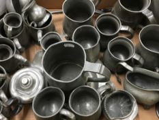A collection of antique pewter tankards, etc.