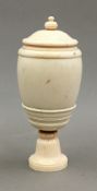 A late 19th century turned ivory pedestal vase and cover