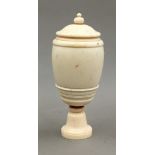 A late 19th century turned ivory pedestal vase and cover