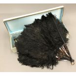 A vintage black ostrich feather fan,