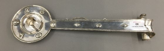 An unmarked Continental silver chamber stick with elongated handle,