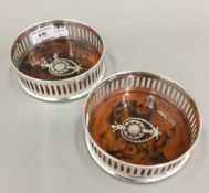 A pair of silver plated coasters